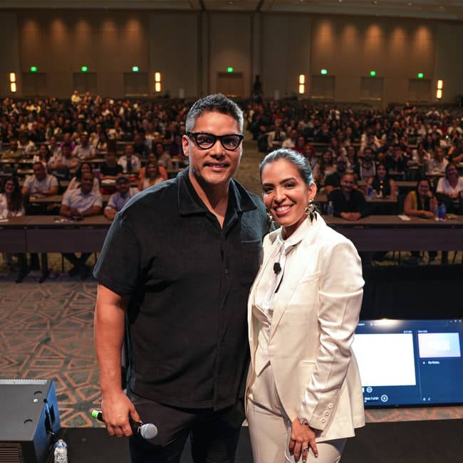 Mario and Andrea Lancioni speaking at a real estate event